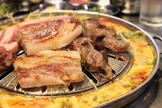 Seoul: Anthony Bourdain-Inspired BBQ and Pub Experience - Stop 1 at Jeongdaepo: galmegisal cooked on charcoal with an egg moat